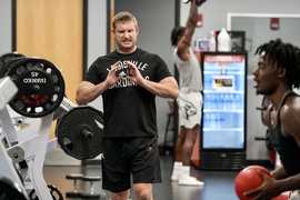 Photo of Adam Petway working with athletes in a gym