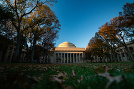 Ground-level view of Killian court in autumn, with leaves on the ground
