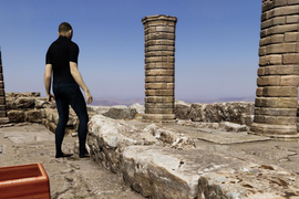 Rendering shows a figure standing in castle ruins, and a wooden box in foreground.