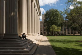 MIT columns looking out onto Killian Court in the summer.