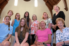 One row of six women standing, one row of four women seated