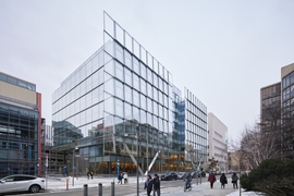 Photo of the facade of the MIT Schwarzman College of Computing building, which features a shingled glass exterior that reflects its surroundings
