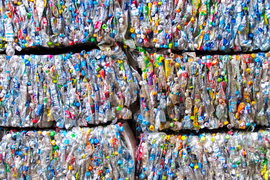 Plastic bottles crunched into stacked bricks.