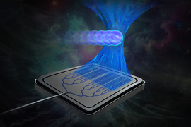 A computer chip focusing a beam of light onto round particles