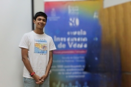 Tomás Orellanastands in front of a blurred-out poster