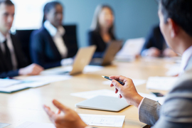 Business people talking around a conference table