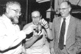 MIT engineer Alexander Rabinovich holds a device he developed with Leslie Bromberg (left), Daniel Cohn (right) and colleagues that could significantly reduce the amount of smog-producing pollutants generated by cars.