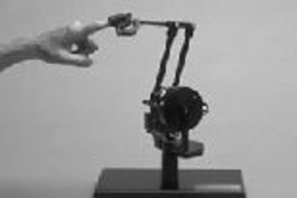 When this PHANToM haptic interface is connected to a desktop computer, it lets the user feel the physical characteristics of the virtual objects she sees on the monitor.