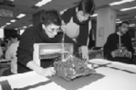 Testing their entry before the 6.270 contest are Joe Levine (left), a junior in mathematics, and one of his partners, Steve Park, a senior in electrical engineering and computer science.