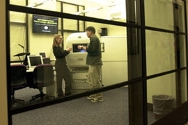 Glass walls and plasma screen displays inform  passersby in the Infinite Corridor of the activities of MIT's new NanoMechanical  Technology Laboratory in Building 8.