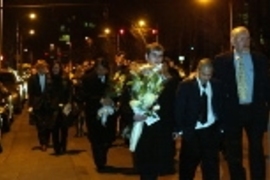 Mourners walk in a procession to the center of the Harvard Bridge where they tossed flowers into the Charles River following the memorial service for Daniel Mun. Right to left: Robert Randolph, senior associate dean for students; Thomas Mun, Daniel's brother; Lowery Duvall, a junior in aeronautics and astronautics and Chi Phi fraternity member; Dr. Andy Mun, Daniel's father.