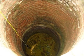 Probing a well to measure its salinity.