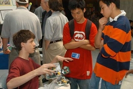 A student from Minnesota's Roosevelt High School InvenTeam explains the team's portable smoke detector for the hearing impaired.