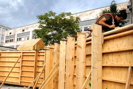 Graduate student Joe Dahmen works inside the wooden cavity used during the wall's construction.