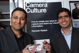 Ramesh Raskar, left, holds box with conventional barcode,
while Ankit Mohan holds a prototype of new Bokode.
