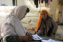 A woman in rural Afghanistan answers questions about the effects of the country's National Solidarity Program.
