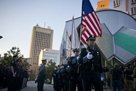 Members of the MIT Police Honor Guard file past the Stata Center as they approach the memorial to Officer Sean Collier at the start of this morning's ceremony.