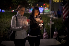 Officer Sean Collier’s sisters held the candles from which all others were lit.