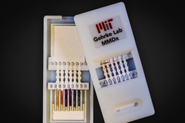 A new paper diagnostic device can detect Ebola as well as other viral hemorrhagic fevers in about 10 minutes. The device (pictured here) has silver nanoparticles of different colors that indicate different diseases. On the left is the unused device, opened to reveal the contents inside. On the right, the device has been used for diagnosis; the colored bands show positive tests.
