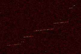 Shown here is "event zero," the first detection of a trapped electron in the MIT physicists' instrument. The color indicates the electron's detected power as a function of frequency and time. The sudden “jumps” in frequency indicate an electron collision with the residual hydrogen gas in the cell.