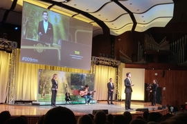 “Team Yellow” demonstrates their product design, called Strum, which offers a way for guitar players to automatically record the notes they play, without having to remember the notes and put down the instrument to record them.offers a way for guitar players to automatically record the notes they play, without having to remember the notes and put down the instrument to record them.
