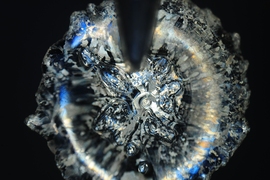 MIT researchers have found a surprising new twist to the mechanics involved when droplets come in contact with surfaces. Pictured here is a microscopic top view of a droplet.
