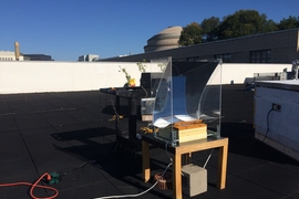 In this experiment, the new steam-generating device was mounted over a basin of water, placed on a small table, and partially surrounded by a simple, transparent solar concentrator. The researchers measured the temperature of the steam produced over the course of the test day, Oct. 21, 2017.
