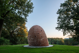 A view of the back of the brick sculpture, with a curved roof.