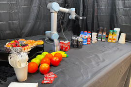 A robot arm surrounded by a variety of objects 