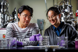 Jeehwan Kim, left, and Zhang look at printed square material in lab.