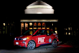 An aluminum electric vehicle in front of MIT’s Great Dome.