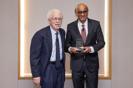 Robert Pozen and Tharman Shanmugaratnam stand together, with Tharman holding a glass award.