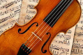 A Stradivarius violin resting on sheet music.