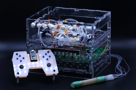 The device’s parts include a controller, like a 3D-printed video game controller, the tube robot, and a plastic-encase computer.