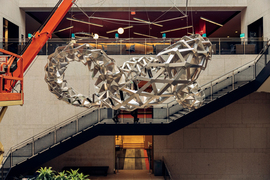 A foldable metal sculpture suspended at the Boston Public Library