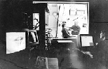 Senior research scientist Joseph S. Perkell (center) attaches electrodes to electrical engineering and computer science graduate student Adrienne Prahler to gather data about speech motor control. Engineer Majid Zandipour (right foreground) operates the computer in an adjoining room.