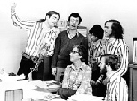 The Logs serenade Julie McLellan, then associate director of admissions, in this mid-1970s photo.