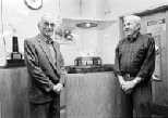John T. Holland (right), range master and varsity pistol coach, stands with retired range master and pistol coach Pat Melaragno, for whom a new women's shooting trophy is named.