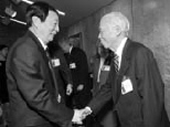 Chinese Premier Zhu Rongji met many prominent MIT faculty members during his visit. Top photo: the Premier (far left) is introduced to Sloan School Dean Richard Schmalensee (right) by President Charles M. Vest (second from left). Behind them are Brit d'Arbeloff (center), wife of MIT Corporation Chairman Alex d'Arbeloff, and Provost Robert A. Brown. Lower photo: Premier Zhu greets Institute Profess...