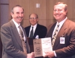 JOINING FORCES--MIT Professor Alan V. Oppenheim (left) with Thomas J. Engibous, Chairman, CEO and President of Texas Instruments (right) and TI DSP research director Bob Hewes. MIT, Rice University and Georgia Tech are each receiving $1 million from TI to establish a collaborative research network in advanced digital signal processing. Professor Oppenheim will oversee the project at MIT.