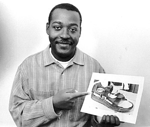 Ronald Demon shows a picture of the frame of the "smart shoe" he developed and patented. Computer chips would be attached to the frame and then a leather or canvas covering would be added to finish the shoe in the desired style.