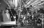 Physics Professors David Pritchard (far left) and Wolfgang Ketterle (far right) watch as visiting scientist Tilman Pfau (second from left) and Shin Inouye, a graduate student student in earth, atmospheric and planetary sciences (second from right) align mirrors on the lab's newest atom laser.