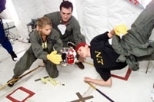 Checking out how well their satellites are performing in microgravity in NASA's KC-135 are (left to right) Professor Dava Newman, consultant Javier deLuis of Payload Systems, Inc., and Dan Feller, a senior in aeronautics and astronautics.
