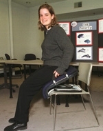Mechanical engineering senior Aimee Angel demonstrates Power-Up, designed to assist people who have difficulty getting up from chairs.