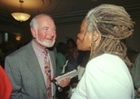 Above, Medical Director Arnold Weinberg chats with pediatrician Janet Moses at his retirement party, where he was roasted by friends and colleagues who at one point displayed an "American Gothic" view of Dr. Weinberg in front of the podium (right).