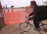 This bicyclist has less traffic and more detours to worry about as he rounds the corner from Massachusetts Avenue to Memorial Drive, where storm drain work has closed off some of the street.