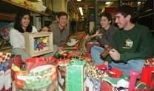 In Professor Steven Leeb's freshman seminar, students made toys that they gave out at a party last Saturday. Associate advisor Maya Chandru (left), a sophomore in physics, creates figures for a puppet theater she designed. Freshmen Carlos Renjifo (second from right) plays with a top he made while freshman Evencio Rosales (right) cranks a handmade noise-maker as Professor Leeb looks on.