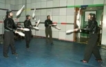 The Flying Karamazov Brothers, demonstrating their juggling and comedy act in the Media Lab atrium, collaborated with Professor Neil Gershenfeld (seated at computer bank at back) and colleagues at the Media Lab to incorporate technology such as sonar tracking of the performers, programmable club displays and interactive computer vision and graphics.