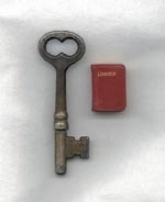 The key measures 2 9/16 inches high. The book is 13/16 by 9/16 inches.