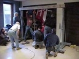 Workers hoist the car to the second floor.